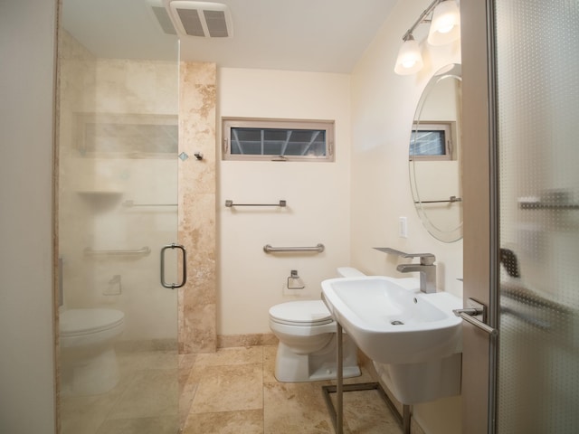 bathroom with tile patterned floors, sink, walk in shower, and toilet