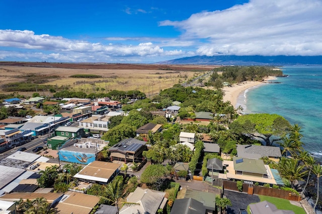 drone / aerial view featuring a water view and a beach view