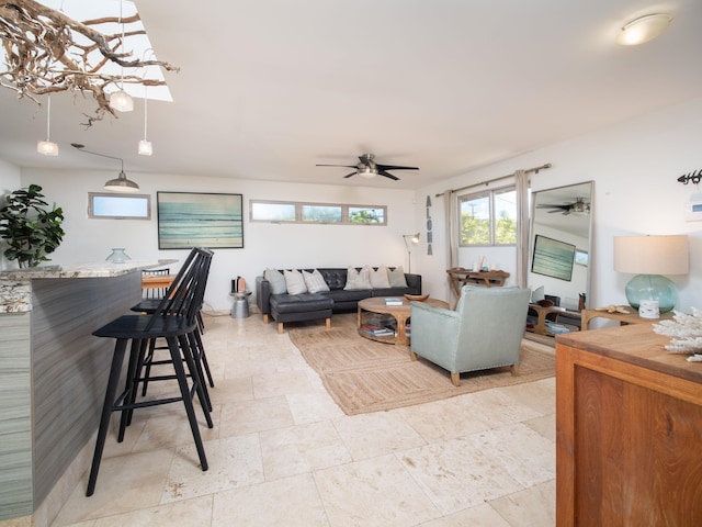 tiled living room with ceiling fan