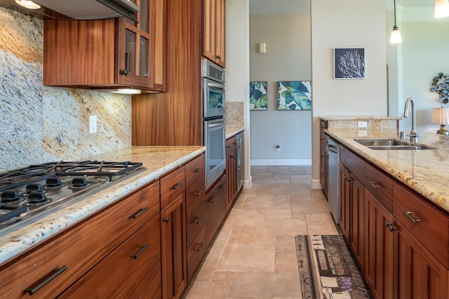 1387 Hihimanu St Unit 16, Kihei, HI 96753 - kitchen with light stone counters, stainless steel appliances, decorative light fixtures, and sink