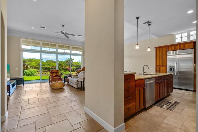 1387 Hihimanu St Unit 16, Kihei, HI 96753 - kitchen with sink, hanging light fixtures, stainless steel appliances, light stone counters, and a healthy amount of sunlight