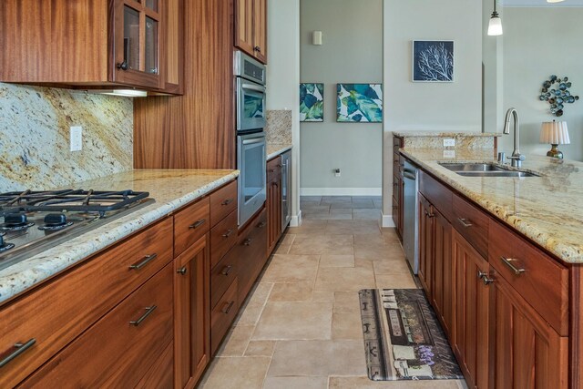 1387 Hihimanu St Unit 16, Kihei, HI 96753 - kitchen with pendant lighting, sink, appliances with stainless steel finishes, tasteful backsplash, and light stone countertops