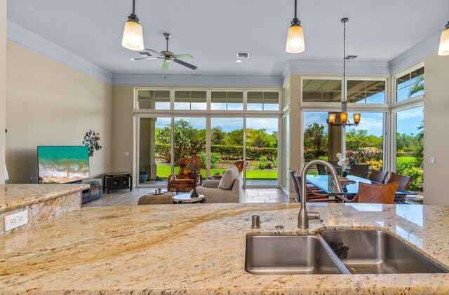 1387 Hihimanu St Unit 16, Kihei, HI 96753 - kitchen featuring pendant lighting, sink, ornamental molding, and light stone countertops
