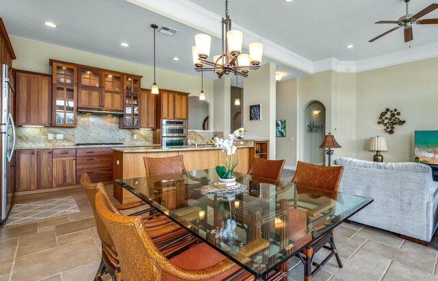 1387 Hihimanu St Unit 16, Kihei, HI 96753 - dining room featuring ornamental molding and ceiling fan with notable chandelier