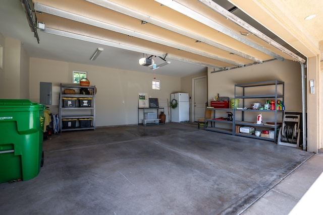 1387 Hihimanu St Unit 16, Kihei, HI 96753 - garage featuring a garage door opener, white fridge, and electric panel