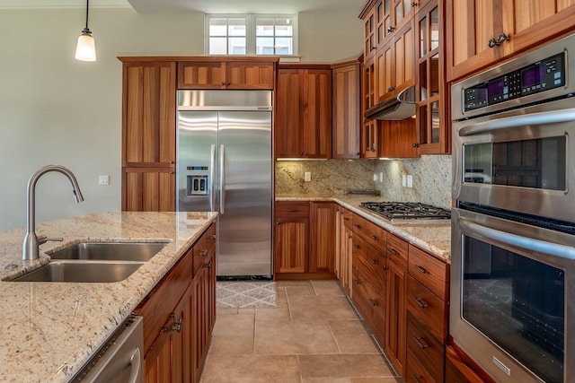 1387 Hihimanu St Unit 16, Kihei, HI 96753 - kitchen with sink, light stone counters, decorative light fixtures, appliances with stainless steel finishes, and backsplash