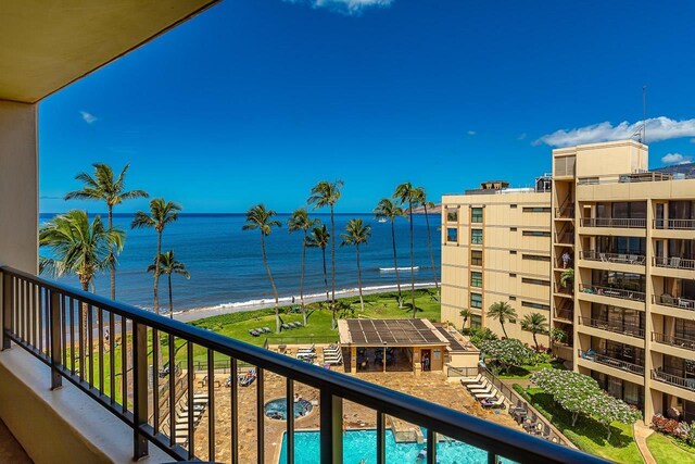 balcony featuring a beach view and a water view