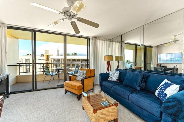 carpeted living room featuring floor to ceiling windows and ceiling fan