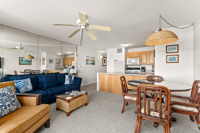 carpeted living room with ceiling fan and lofted ceiling