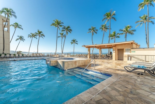 view of swimming pool with a jacuzzi and a patio area