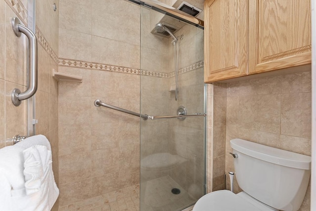 bathroom featuring toilet and walk in shower