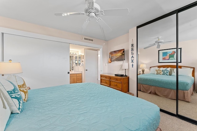 carpeted bedroom featuring ceiling fan and a closet