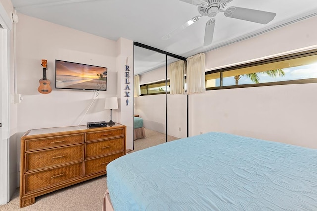 carpeted bedroom featuring a closet and ceiling fan