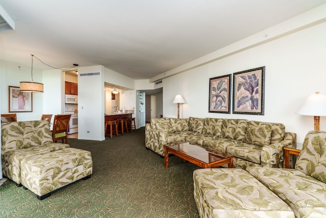 living room with dark colored carpet