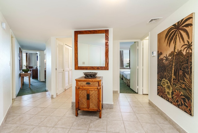 hall with light tile patterned floors