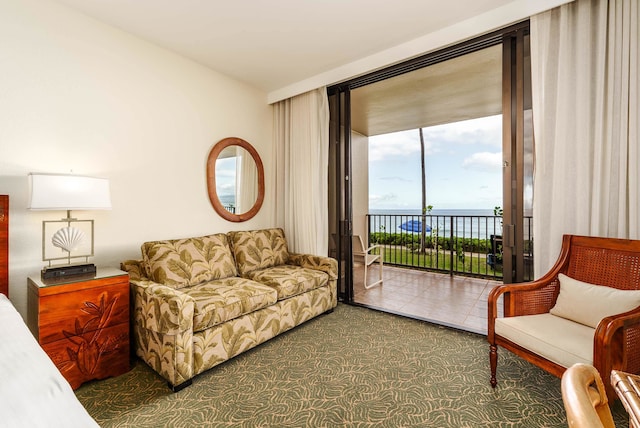 carpeted living room featuring a water view and a wall of windows