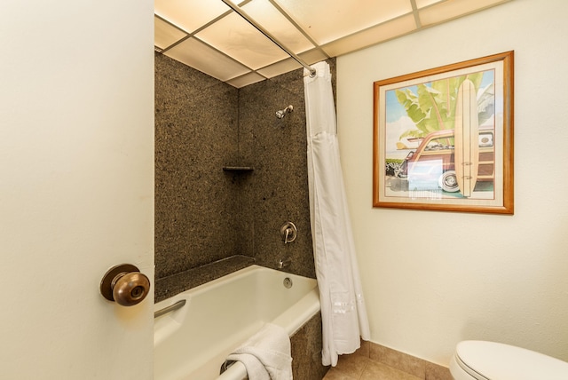 bathroom with toilet, shower / bath combo with shower curtain, and tile patterned floors