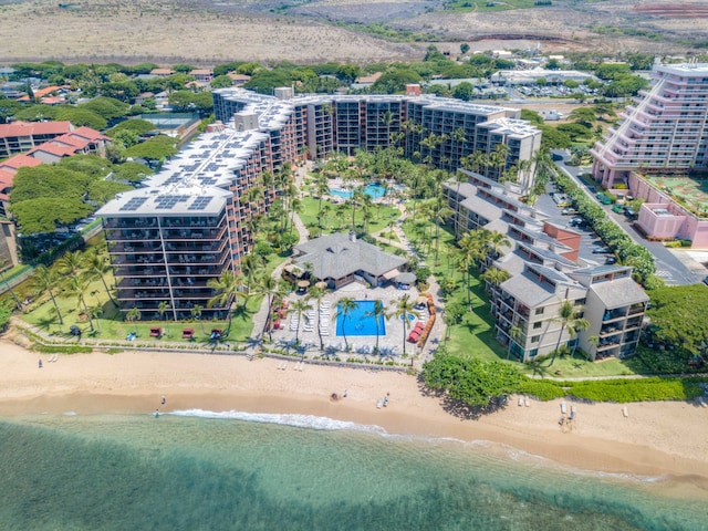 drone / aerial view with a water view and a beach view