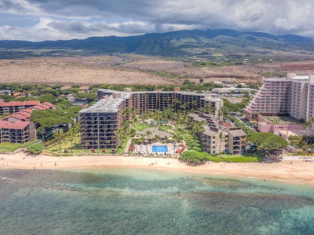 birds eye view of property featuring a water and mountain view and a view of the beach