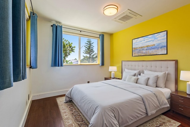 bedroom featuring dark wood-style flooring, visible vents, and baseboards