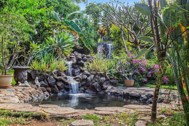 exterior space with a garden pond