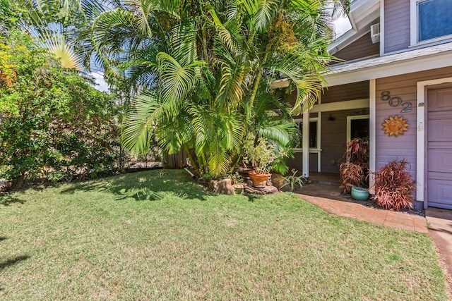 view of yard with a garage and a porch