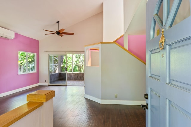 unfurnished room featuring hardwood / wood-style floors, ceiling fan, baseboards, and an AC wall unit