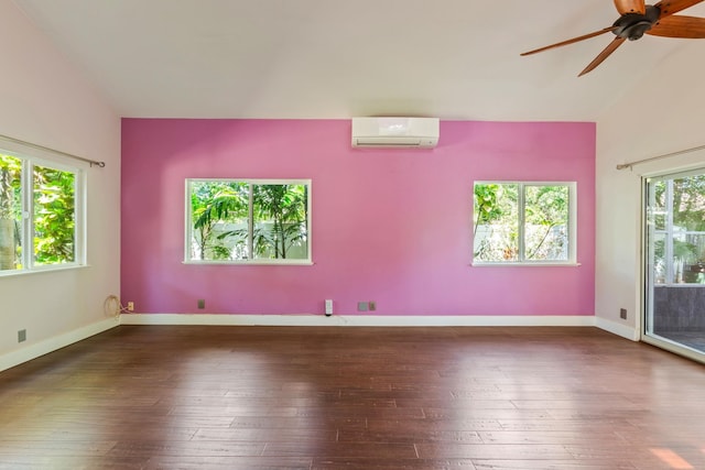 empty room featuring lofted ceiling, ceiling fan, hardwood / wood-style flooring, baseboards, and a wall mounted AC