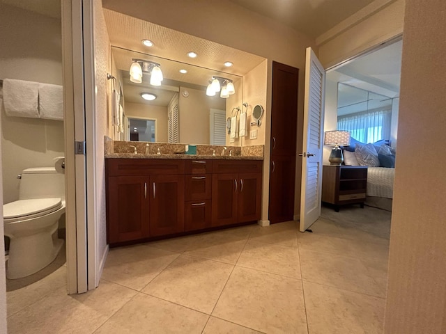 bathroom featuring toilet, vanity, and tile patterned floors