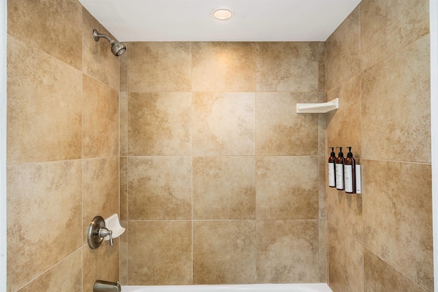 interior details featuring tiled shower / bath