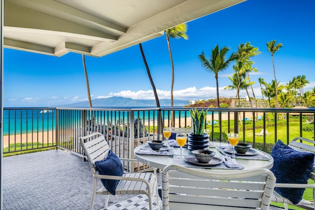 balcony with a water view and a beach view