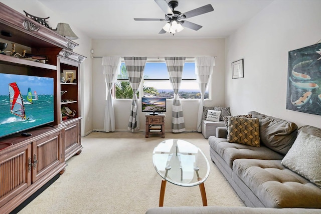 living room with a ceiling fan and light carpet