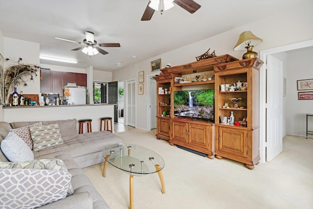 living room with a ceiling fan and light carpet