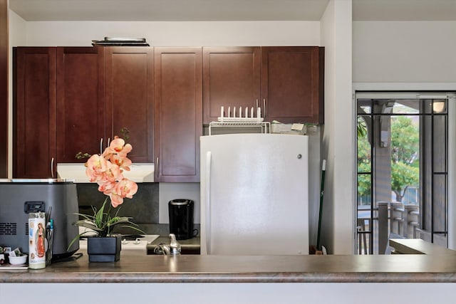 kitchen featuring freestanding refrigerator