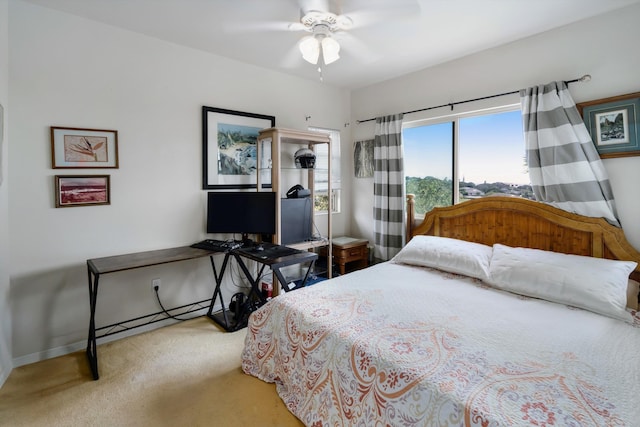 carpeted bedroom with baseboards and a ceiling fan