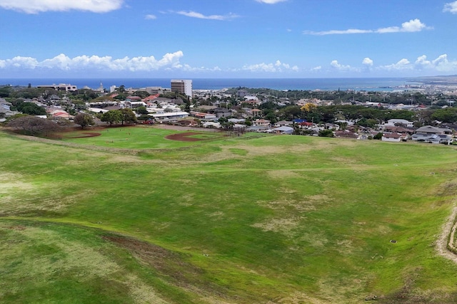 drone / aerial view featuring a water view, golf course view, and a residential view