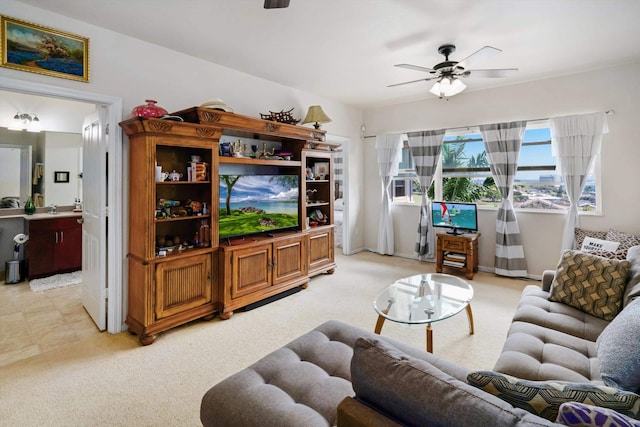 living area with ceiling fan and light carpet