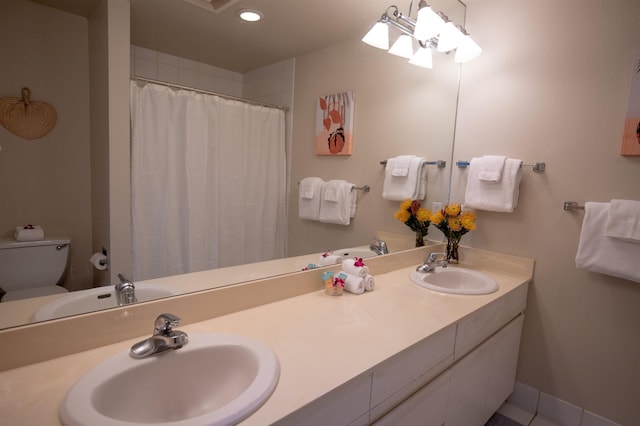 bathroom with vanity, a shower with shower curtain, and toilet