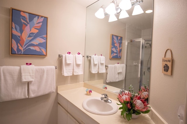 bathroom with vanity and a shower with shower door