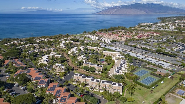 birds eye view of property with a water and mountain view