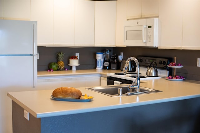 kitchen with white cabinets and white appliances