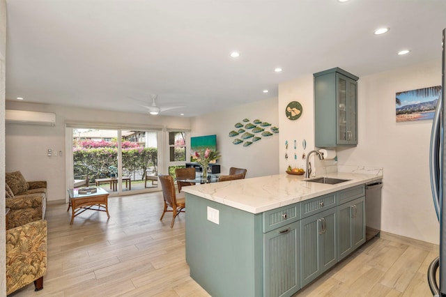 1299 Uluniu Rd Unit 106C, Kihei, HI 96753 - kitchen featuring stainless steel dishwasher, light wood finished floors, a wall mounted AC, recessed lighting, and light stone countertops