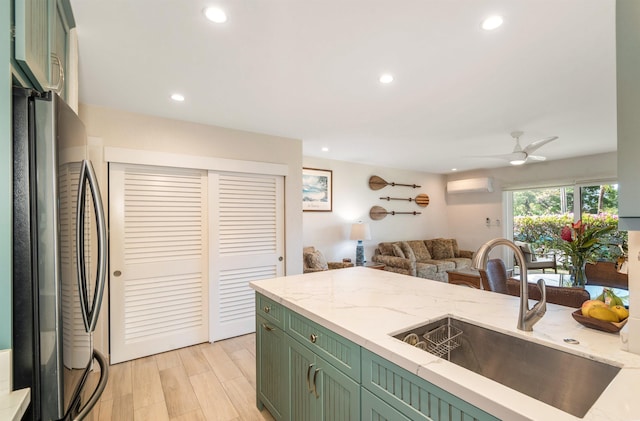 1299 Uluniu Rd Unit 106C, Kihei, HI 96753 - kitchen featuring green cabinets, freestanding refrigerator, open floor plan, recessed lighting, and a wall unit AC