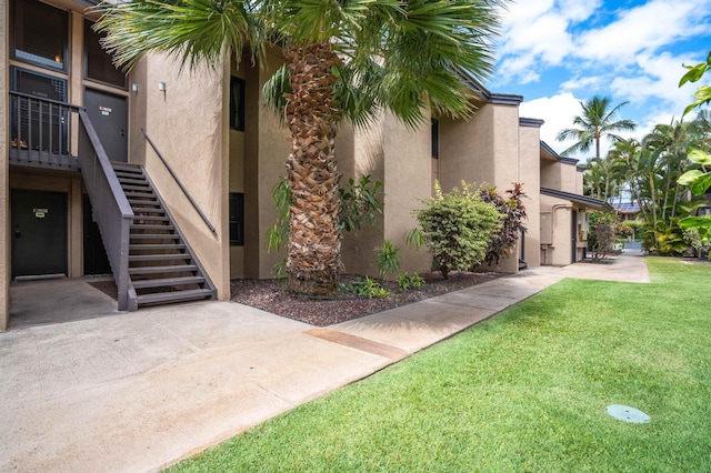 1299 Uluniu Rd Unit 106C, Kihei, HI 96753 - view of building exterior featuring stairs
