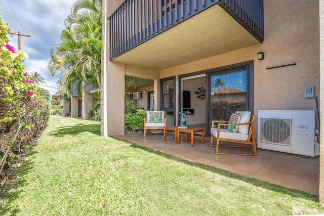 1299 Uluniu Rd Unit 106C, Kihei, HI 96753 - view of green lawn with a patio, a balcony, and a wall mounted air conditioner