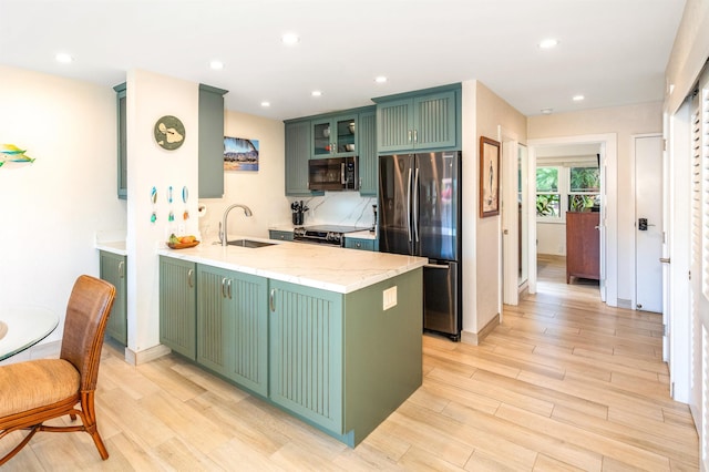 1299 Uluniu Rd Unit 106C, Kihei, HI 96753 - kitchen featuring appliances with stainless steel finishes, green cabinetry, a peninsula, light wood finished floors, and recessed lighting