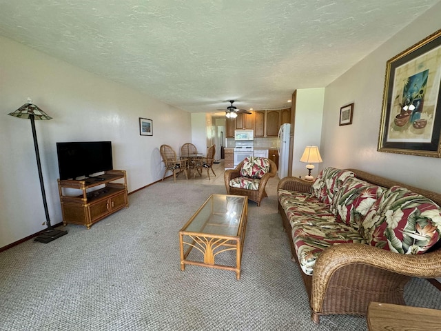 7146 Kamehameha V Hwy Unit C107, Kaunakakai, HI 96748 - living area featuring light carpet, ceiling fan, a textured ceiling, and baseboards