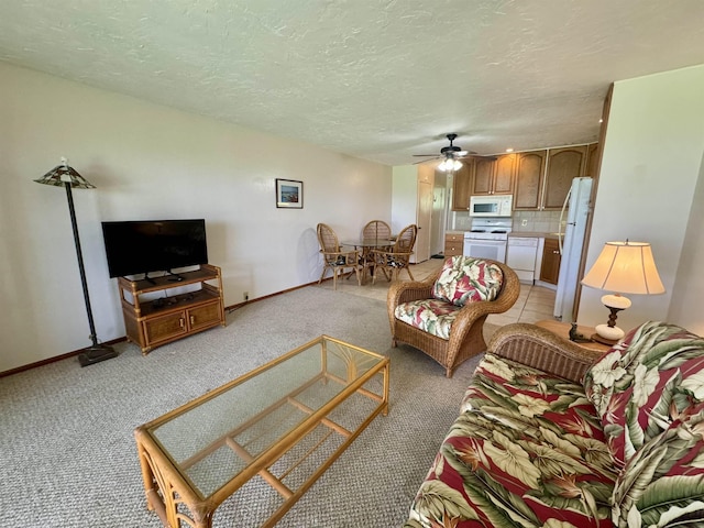 7146 Kamehameha V Hwy Unit C107, Kaunakakai, HI 96748 - living area with light colored carpet, a ceiling fan, baseboards, and a textured ceiling