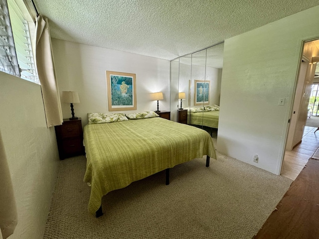 7146 Kamehameha V Hwy Unit C107, Kaunakakai, HI 96748 - bedroom featuring wood finished floors and a textured ceiling