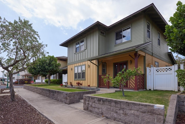 62 Meheu Cir, Kahului, HI 96732 - view of front of home with board and batten siding, covered porch, fence, a front lawn, and a gate